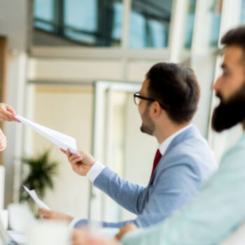 Business Team handing over paper