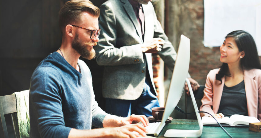 Business Team working together on a mac