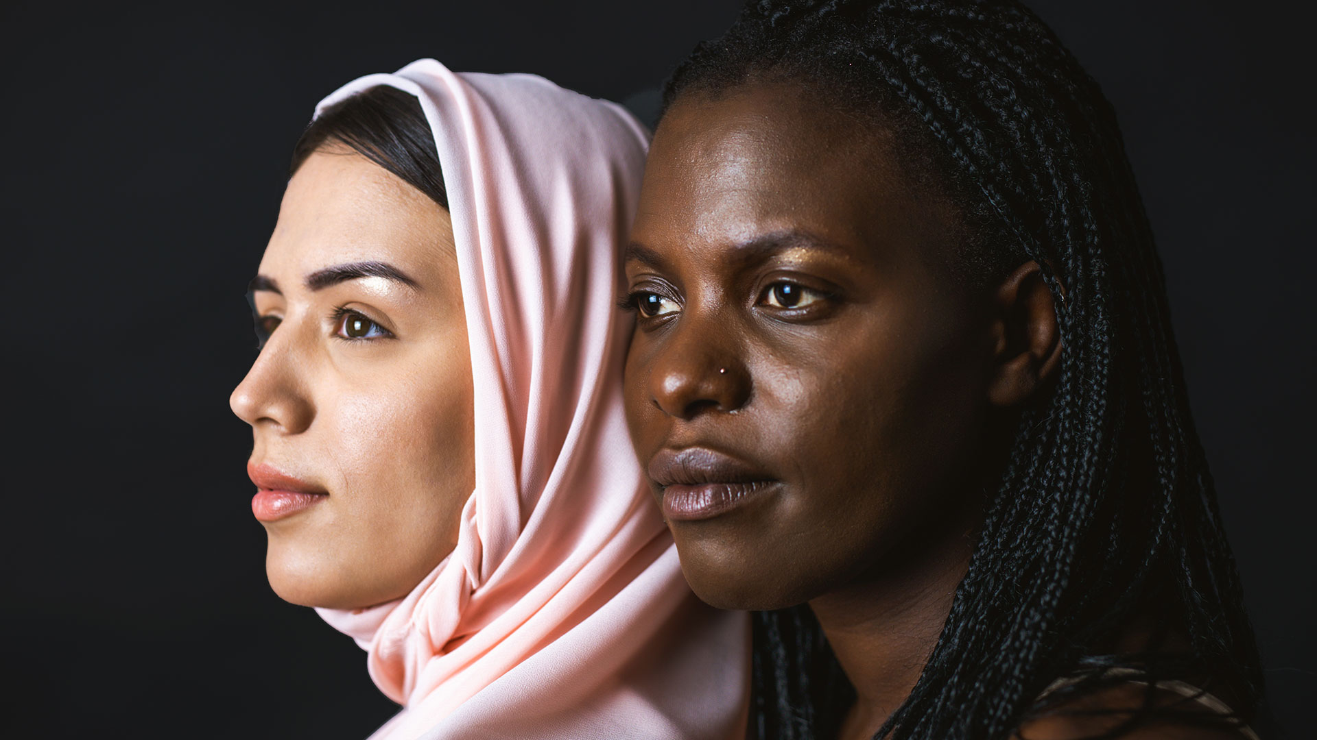 Two Multiracial Women Looking To The Left