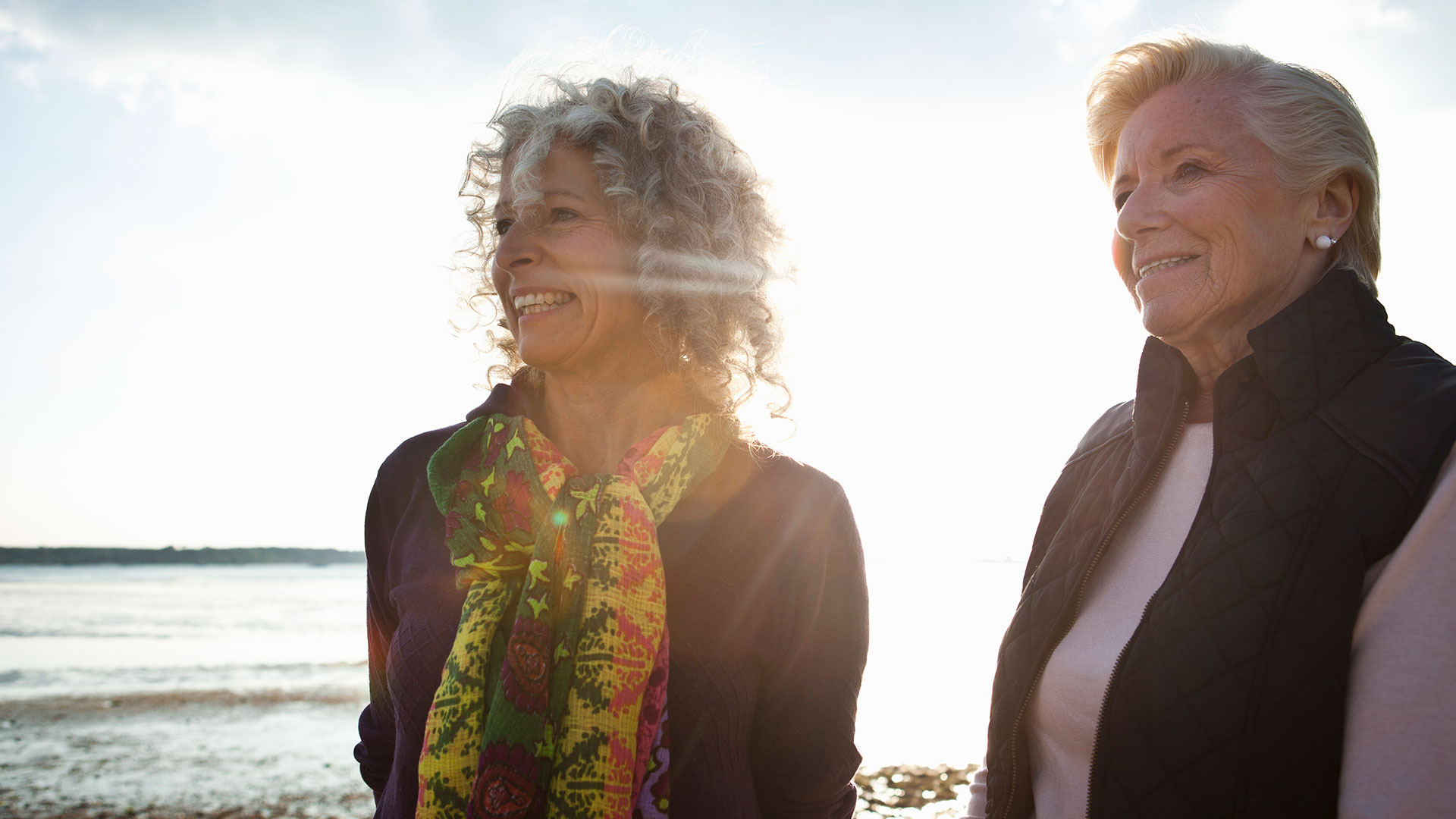 Mother And Daughter Enjoying View On Beach
